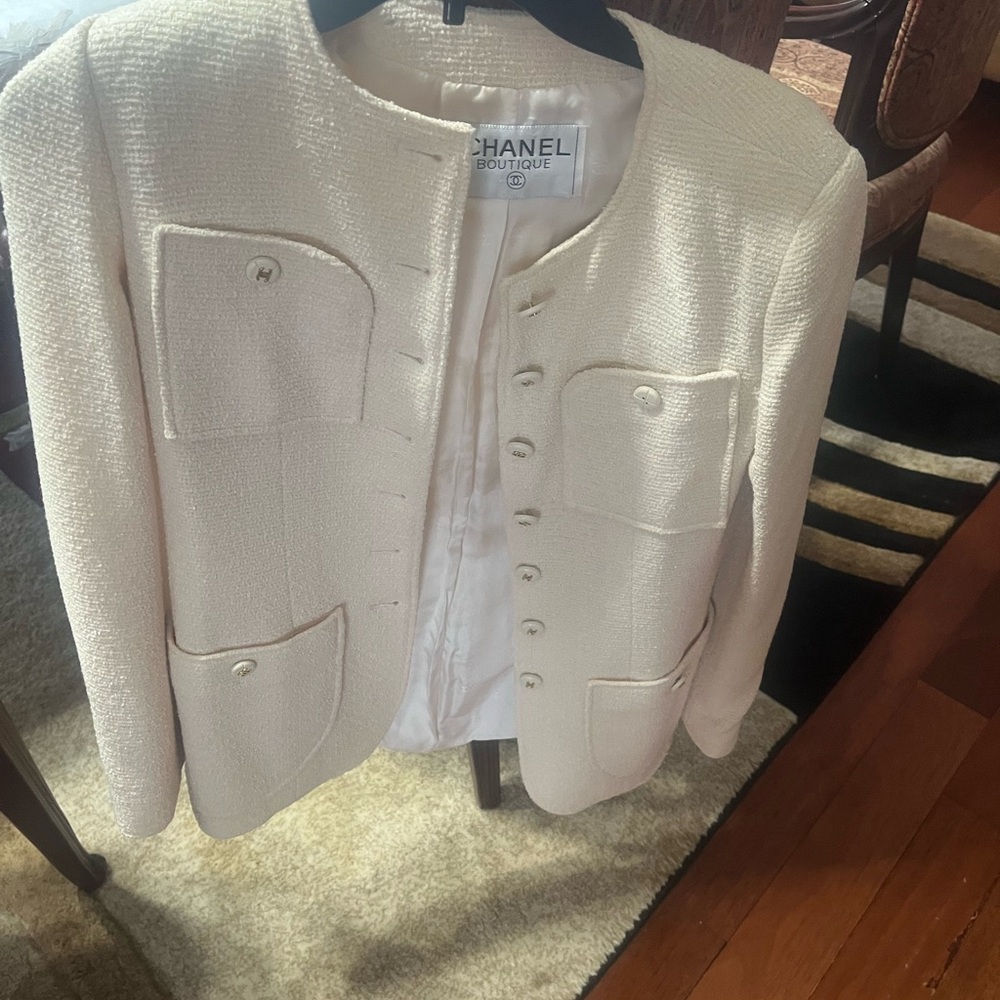 Chanel Women's cream boucle jacket featuring four patch pockets